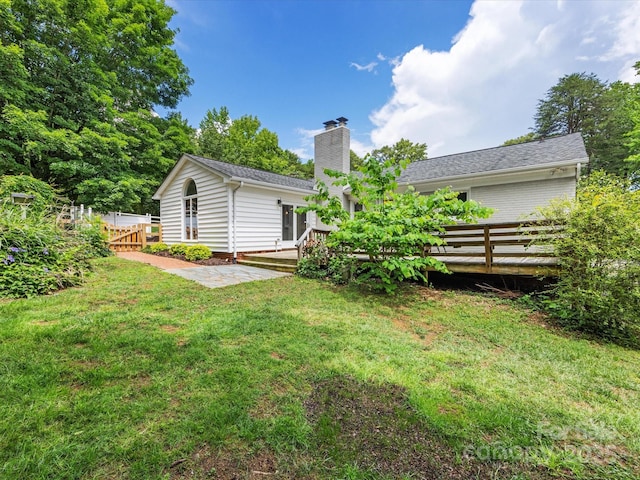 1031 Eldorado Ave, Charlotte, NC 28262 - rear view of house featuring a chimney and a wooden deck