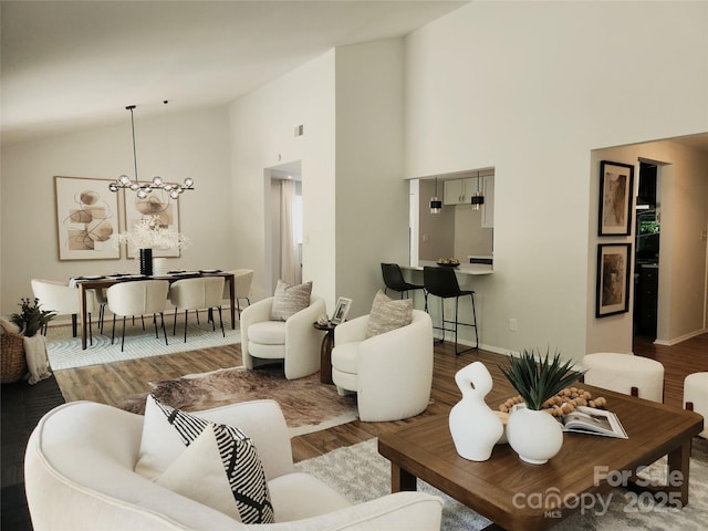7228 Rollingridge Dr, Charlotte, NC 28211 - living area with wood finished floors, high vaulted ceiling, a chandelier, and baseboards