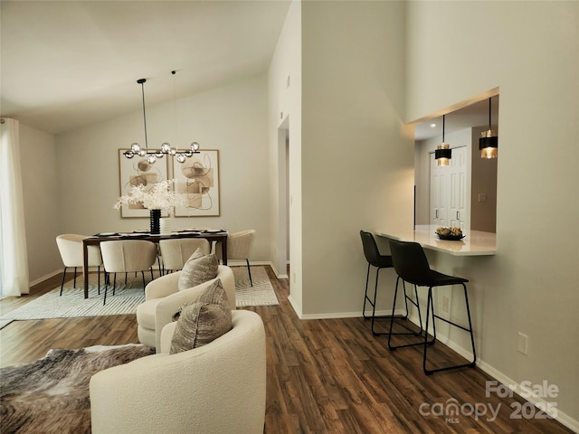7228 Rollingridge Dr, Charlotte, NC 28211 - living area with dark wood-type flooring, baseboards, high vaulted ceiling, and a chandelier