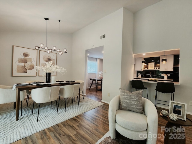 7228 Rollingridge Dr, Charlotte, NC 28211 - dining room with wood finished floors, a high ceiling, and baseboards