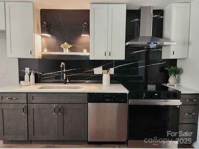 7228 Rollingridge Dr, Charlotte, NC 28211 - kitchen with electric range, stainless steel dishwasher, wall chimney exhaust hood, a sink, and tasteful backsplash