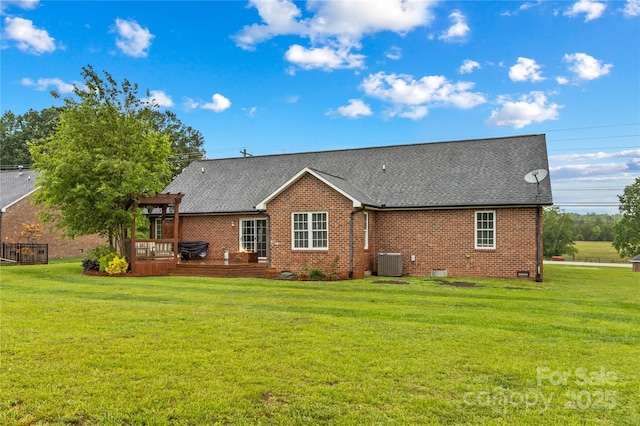 back of house featuring brick siding, a deck, central air condition unit, and a lawn