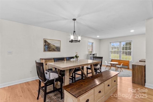 dining area featuring light wood-style floors, baseboards, recessed lighting, and a chandelier