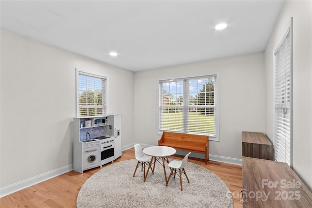 playroom featuring baseboards, light wood-type flooring, and recessed lighting