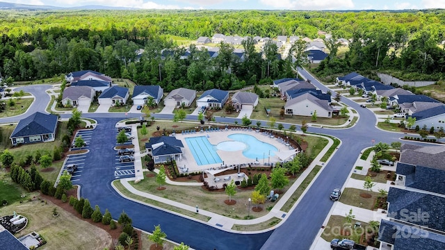 1825 Lotus Ln, Denver, NC 28037 - aerial view of property and surrounding area featuring a heavily wooded area, a pool, and nearby suburban area