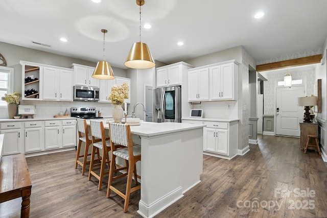 4842 Durneigh Dr, Kannapolis, NC 28081 - kitchen with stainless steel appliances, decorative backsplash, light countertops, white cabinets, and recessed lighting