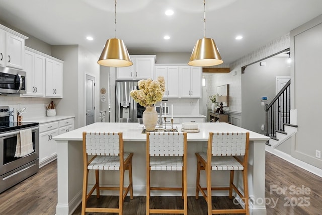 4842 Durneigh Dr, Kannapolis, NC 28081 - kitchen featuring stainless steel appliances, decorative backsplash, a center island with sink, dark wood finished floors, and recessed lighting