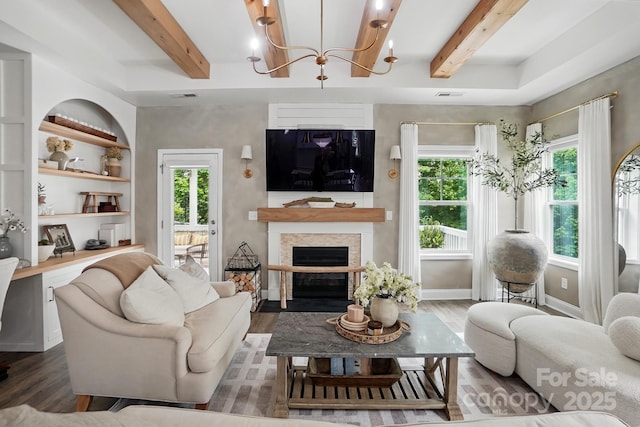 4842 Durneigh Dr, Kannapolis, NC 28081 - living area with beamed ceiling, wood finished floors, a chandelier, a fireplace with flush hearth, and baseboards