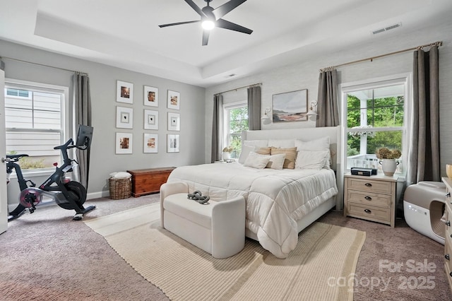 4842 Durneigh Dr, Kannapolis, NC 28081 - bedroom with a tray ceiling, light carpet, ceiling fan, and baseboards
