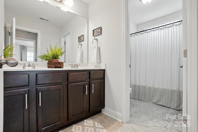 4842 Durneigh Dr, Kannapolis, NC 28081 - full bathroom featuring double vanity, tile patterned floors, toilet, and curtained shower