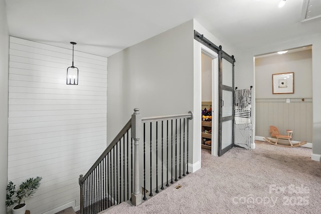 4842 Durneigh Dr, Kannapolis, NC 28081 - hallway with a barn door, carpet flooring, and an upstairs landing