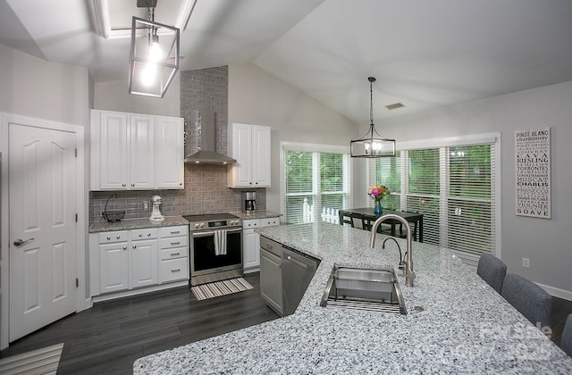 kitchen featuring stainless steel appliances, a sink, backsplash, white cabinets, and dark wood finished floors