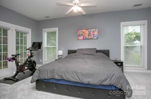 carpeted bedroom featuring baseboards and ceiling fan