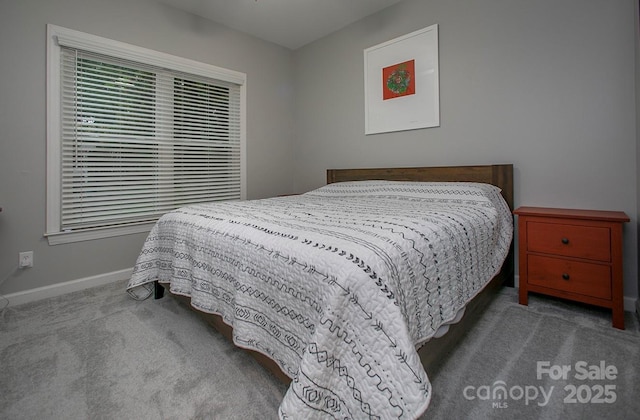 carpeted bedroom featuring baseboards