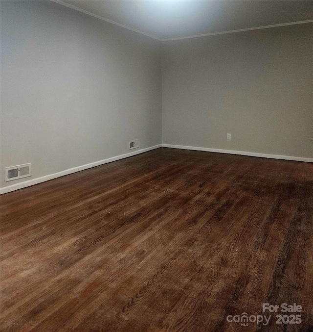 1412 Wembley Dr, Charlotte, NC 28205 - spare room featuring crown molding, dark wood-style floors, and baseboards