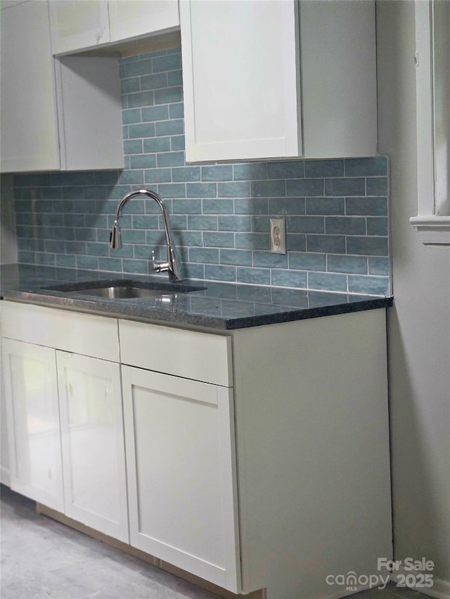 1412 Wembley Dr, Charlotte, NC 28205 - kitchen featuring tasteful backsplash, white cabinetry, dark stone counters, and a sink