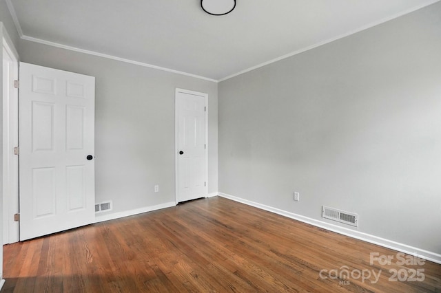 1412 Wembley Dr, Charlotte, NC 28205 - unfurnished bedroom with baseboards, ornamental molding, and dark wood-style floors