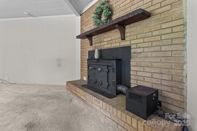 unfurnished living room featuring carpet flooring, a wood stove, and wooden walls
