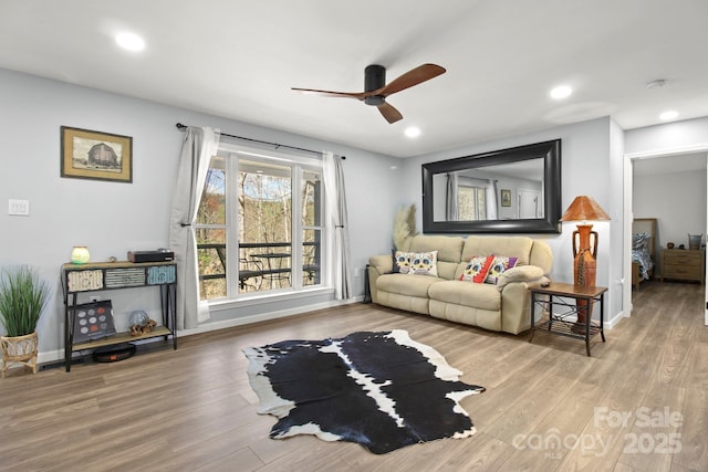 living area with ceiling fan, wood finished floors, baseboards, and recessed lighting