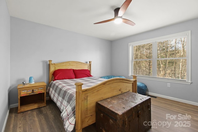 bedroom with baseboards, wood finished floors, and ceiling fan