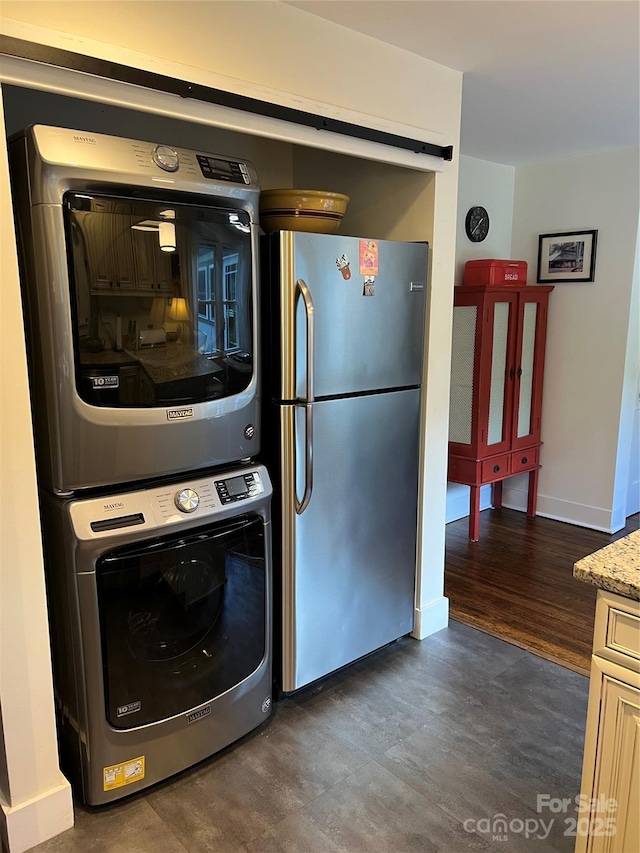 6 Craggy Cir, Asheville, NC 28803 - kitchen featuring freestanding refrigerator, estacked washer and dryer, dark wood-style flooring, and light stone counters