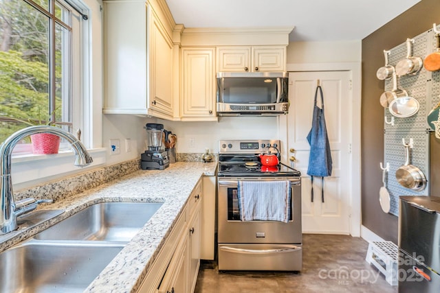 6 Craggy Cir, Asheville, NC 28803 - kitchen with appliances with stainless steel finishes, cream cabinetry, and light stone countertops