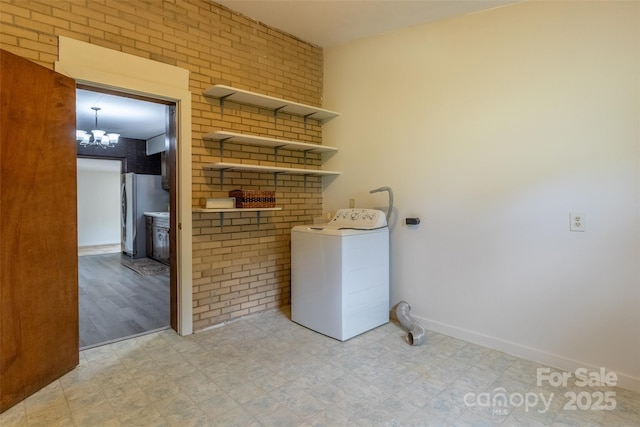 washroom with washer / dryer, light floors, and baseboards