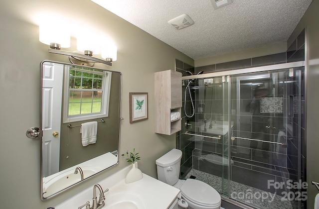 1610 Ford St, Charlotte, NC 28216 - full bathroom with a textured ceiling, a shower stall, toilet, and vanity
