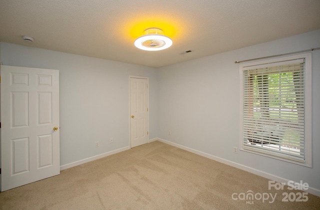 1610 Ford St, Charlotte, NC 28216 - unfurnished room featuring light colored carpet, baseboards, and a textured ceiling