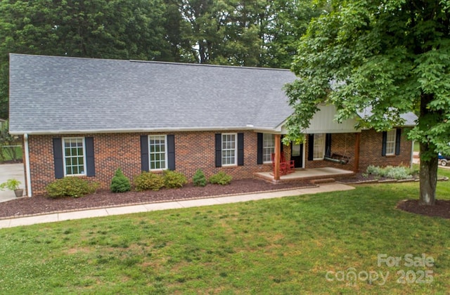 1610 Ford St, Charlotte, NC 28216 - view of front of property with a front lawn, a porch, brick siding, and a shingled roof