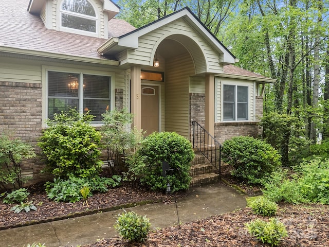 5 Governors Dr, Hendersonville, NC 28791 - view of exterior entry featuring roof with shingles and brick siding