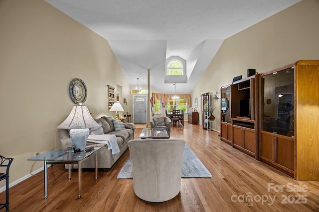 5 Governors Dr, Hendersonville, NC 28791 - living room featuring a chandelier, high vaulted ceiling, light wood-style flooring, and baseboards