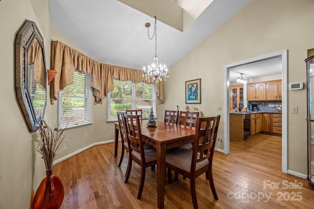 5 Governors Dr, Hendersonville, NC 28791 - dining space with light wood-type flooring, a chandelier, high vaulted ceiling, and baseboards
