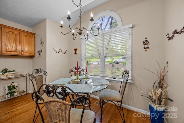 5 Governors Dr, Hendersonville, NC 28791 - dining room with lofted ceiling, light wood-style floors, baseboards, and a chandelier
