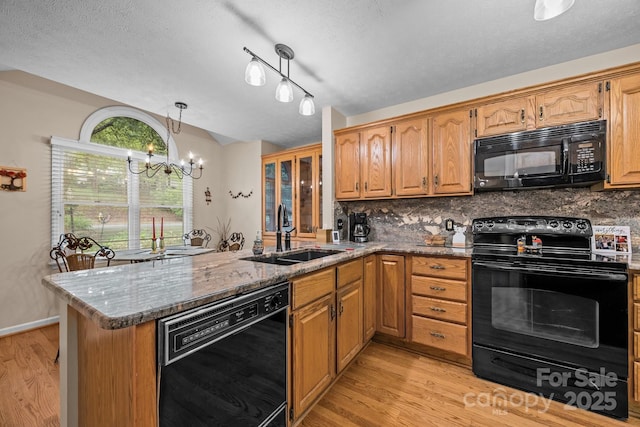 5 Governors Dr, Hendersonville, NC 28791 - kitchen featuring black appliances, a sink, light wood finished floors, a peninsula, and a chandelier