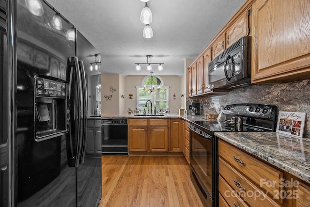 5 Governors Dr, Hendersonville, NC 28791 - kitchen with black appliances, a sink, light wood-type flooring, brown cabinets, and decorative backsplash