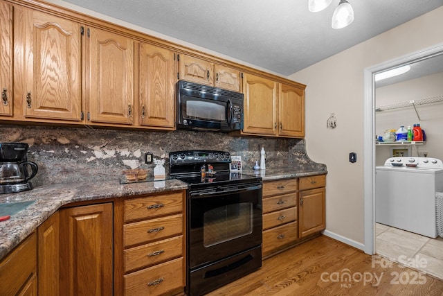5 Governors Dr, Hendersonville, NC 28791 - kitchen featuring black appliances, washer / dryer, tasteful backsplash, brown cabinets, and light wood-style floors