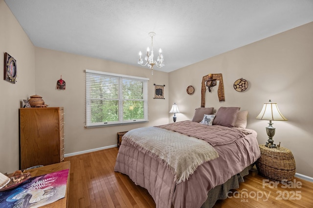 5 Governors Dr, Hendersonville, NC 28791 - bedroom featuring a chandelier, hardwood / wood-style floors, and baseboards
