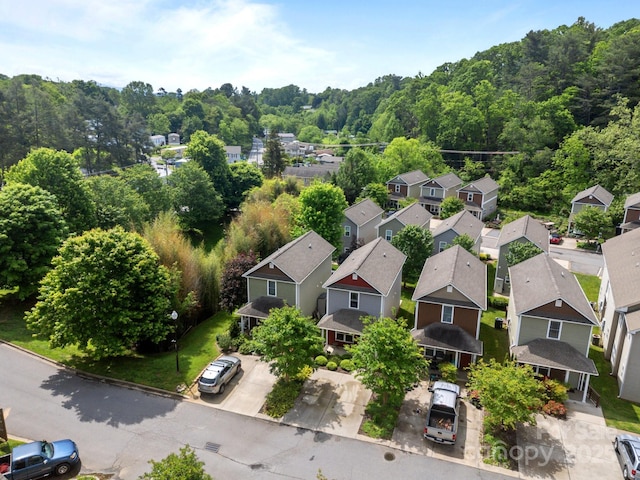 aerial view of residential area featuring a forest