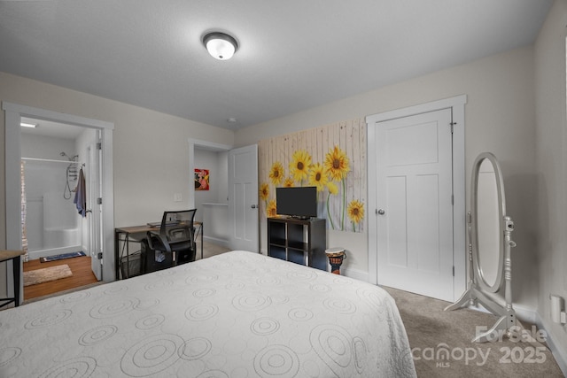 carpeted bedroom with connected bathroom