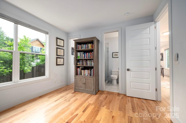 77 5th Ave, Asheville, NC 28806 - unfurnished bedroom with light wood-type flooring and ensuite bathroom