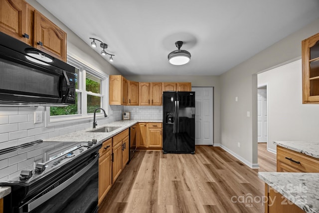 16 Lake Forest Ln, Hendersonville, NC 28739 - kitchen featuring black appliances, a sink, light wood finished floors, backsplash, and light stone countertops