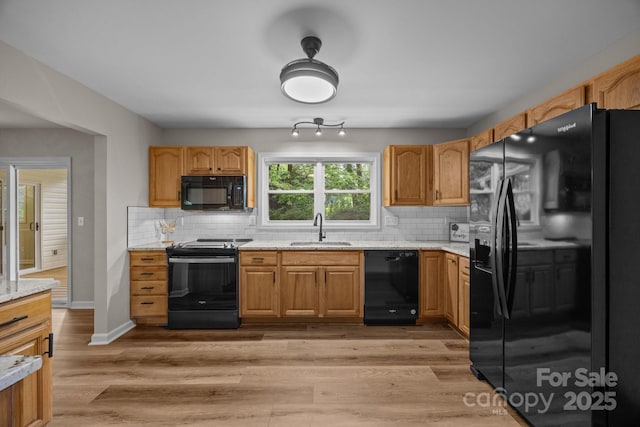 16 Lake Forest Ln, Hendersonville, NC 28739 - kitchen featuring black appliances, a sink, decorative backsplash, and light wood-style floors