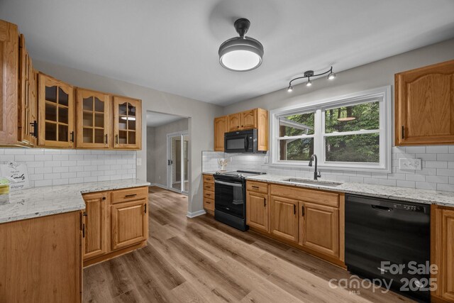 16 Lake Forest Ln, Hendersonville, NC 28739 - kitchen featuring black appliances, a sink, backsplash, glass insert cabinets, and light stone countertops