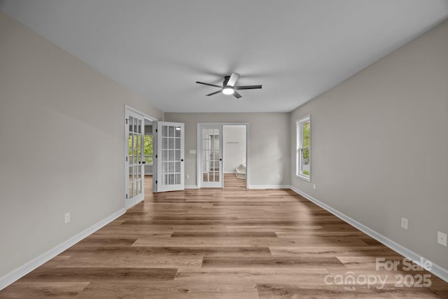 16 Lake Forest Ln, Hendersonville, NC 28739 - empty room with french doors, ceiling fan, plenty of natural light, and baseboards