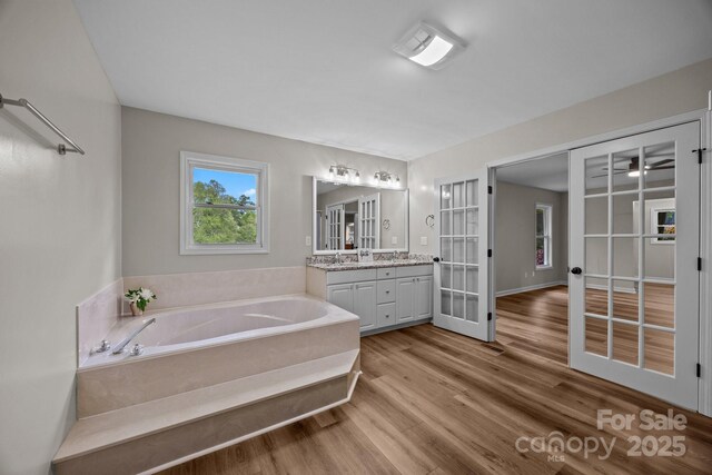 16 Lake Forest Ln, Hendersonville, NC 28739 - full bathroom with french doors, wood finished floors, a garden tub, and vanity