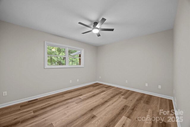 16 Lake Forest Ln, Hendersonville, NC 28739 - spare room with wood finished floors, baseboards, and a ceiling fan