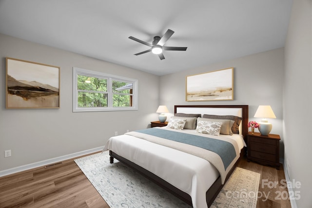16 Lake Forest Ln, Hendersonville, NC 28739 - bedroom with wood finished floors, baseboards, and a ceiling fan