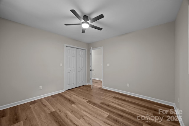 16 Lake Forest Ln, Hendersonville, NC 28739 - unfurnished bedroom with baseboards, wood finished floors, and a closet