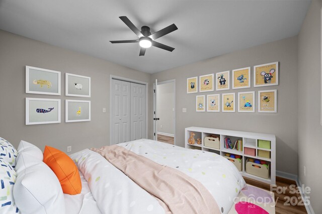16 Lake Forest Ln, Hendersonville, NC 28739 - bedroom featuring a closet, wood finished floors, baseboards, and ceiling fan